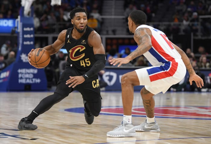 Nov 27, 2022; Detroit, Michigan, USA; Cleveland Cavaliers guard Donovan Mitchell (45) dribbles against Detroit Pistons guard Rodney McGruder (17) in the first quarter at Little Caesars Arena. Mandatory Credit: Lon Horwedel-USA TODAY